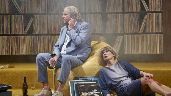 Szenenfoto The Party, Janet (Dörte Lyssewski) liegt am Boden, neben ihr sitzt Bill (Peter Simonischek).
